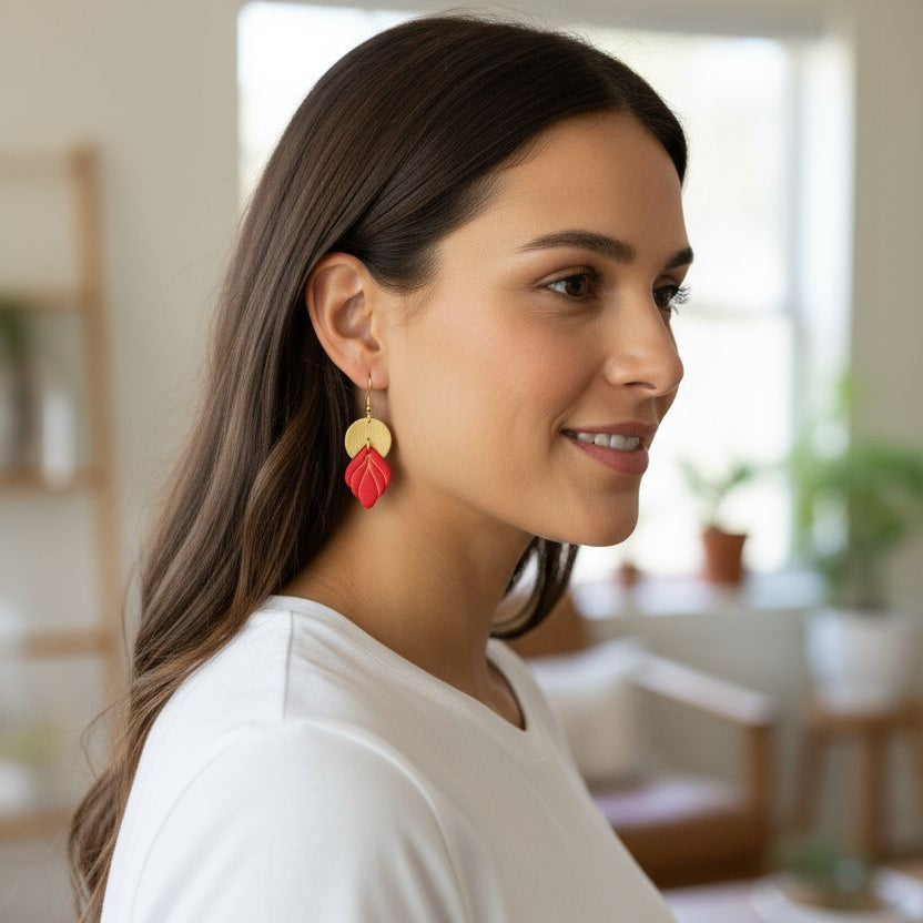 Model wearing Handmade red and gold statement earrings with polymer clay and gold accents