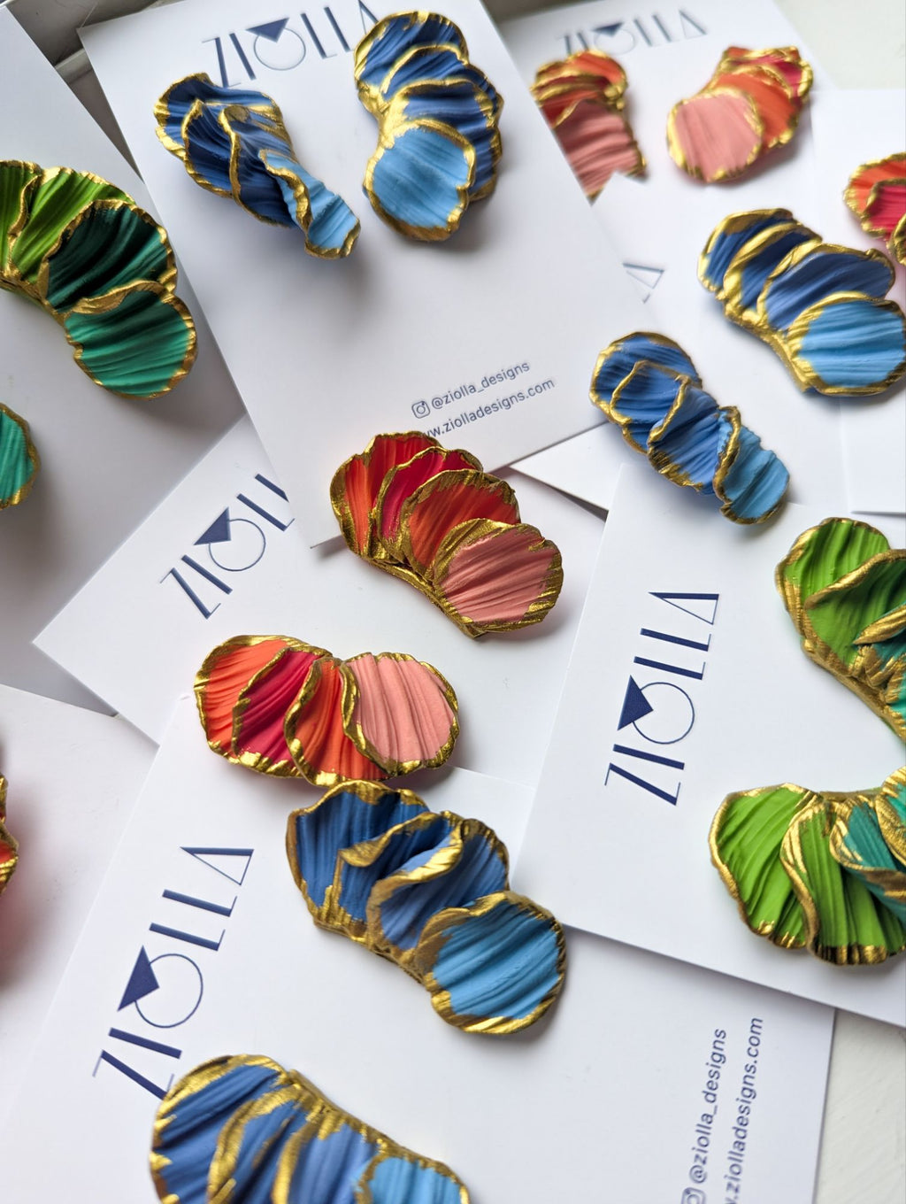 Colorful earrings on a Ziolla Designs branded card