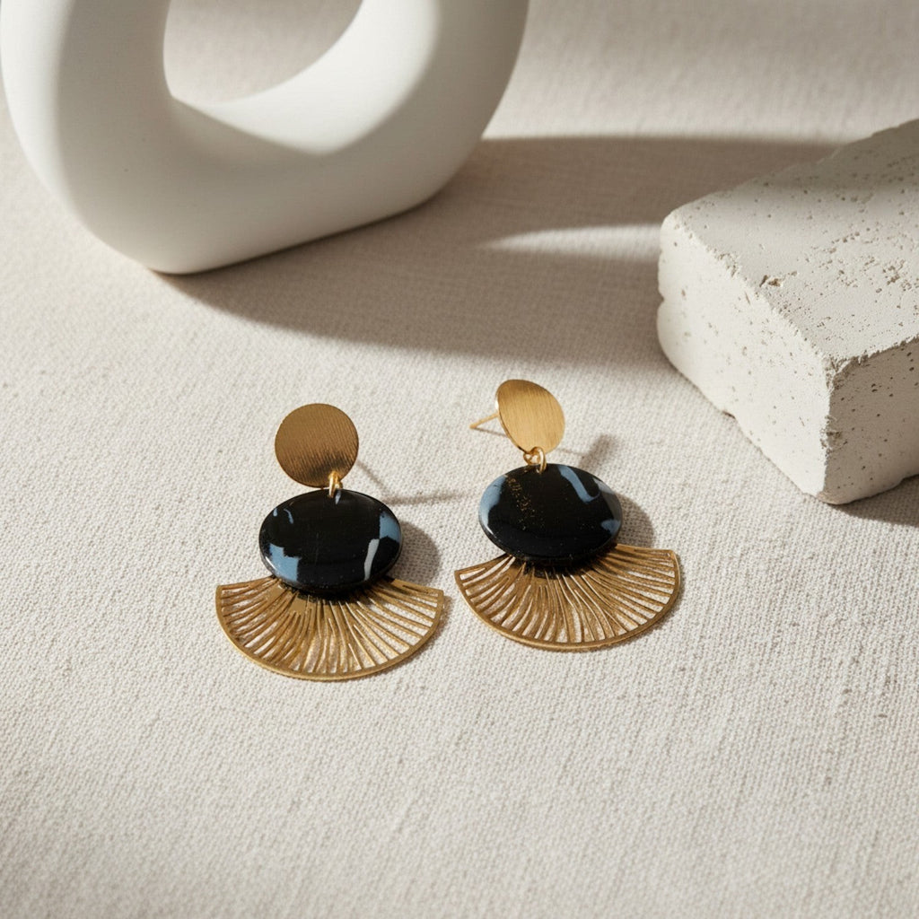 Ziolla Designs Roberta earrings: black marbled resin discs with brushed gold fan details. Art Deco style.