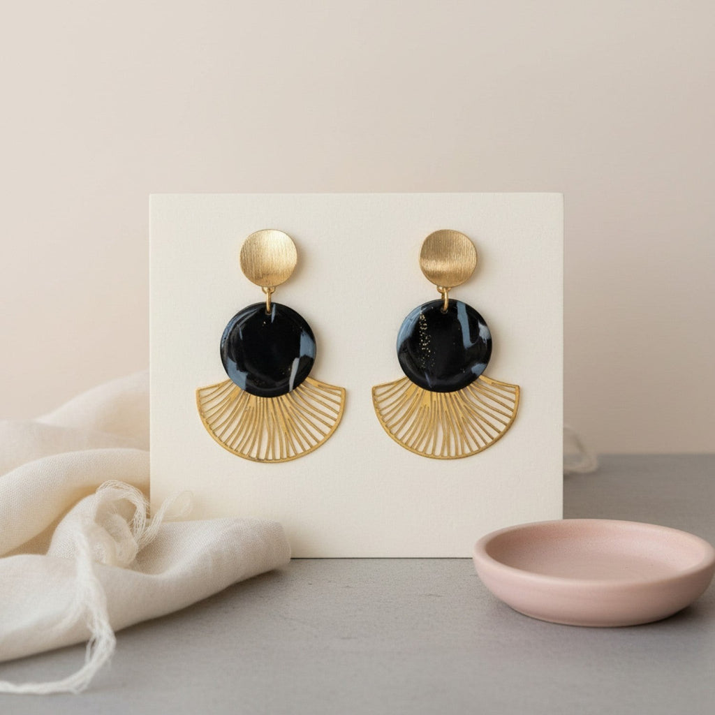 Ziolla Designs Roberta earrings: black marbled resin discs with gold fan detail. Art Deco style statement drops.